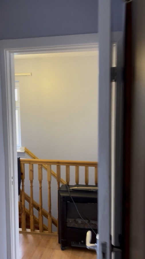 A repainted landing with a timber banister