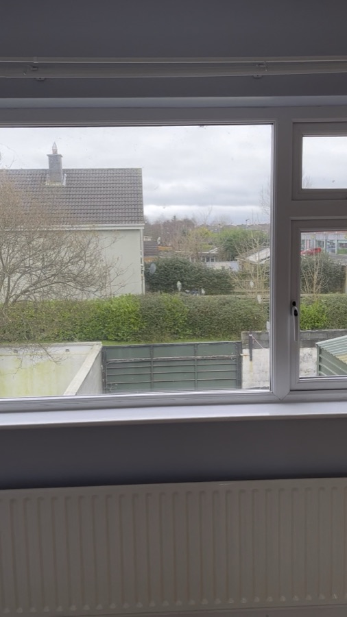 A freshly painted room with a window and radiator